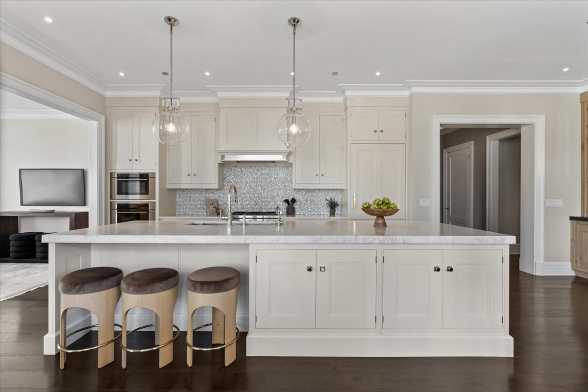 9 West Walton Street, Unit 702 Chicago, IL 60610 - Photo 9 of 38 a large white kitchen with a sink and cabinets