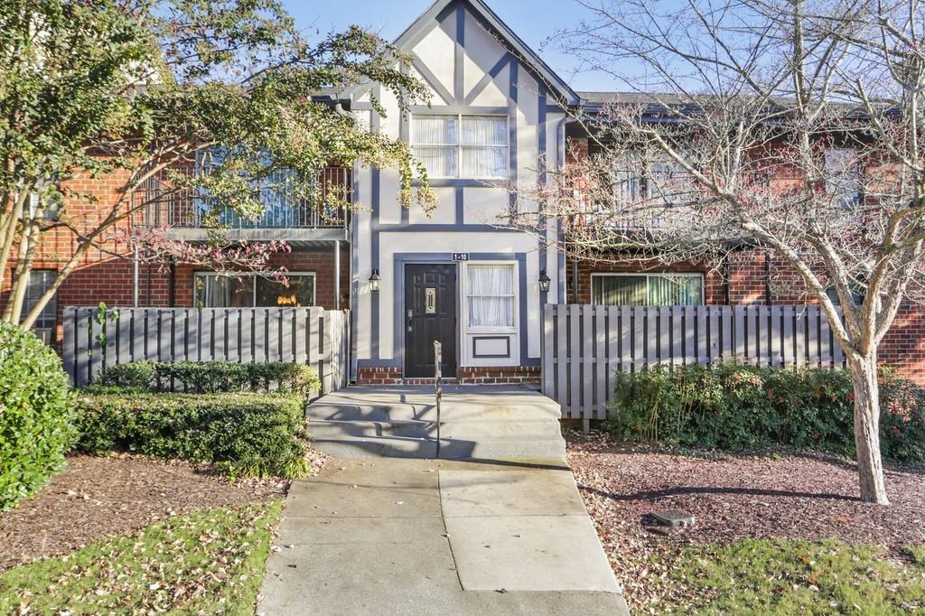 6851 Roswell Road, Unit O2 Atlanta, GA 30328 - Photo 1 of 1 a front view of a house with a garden