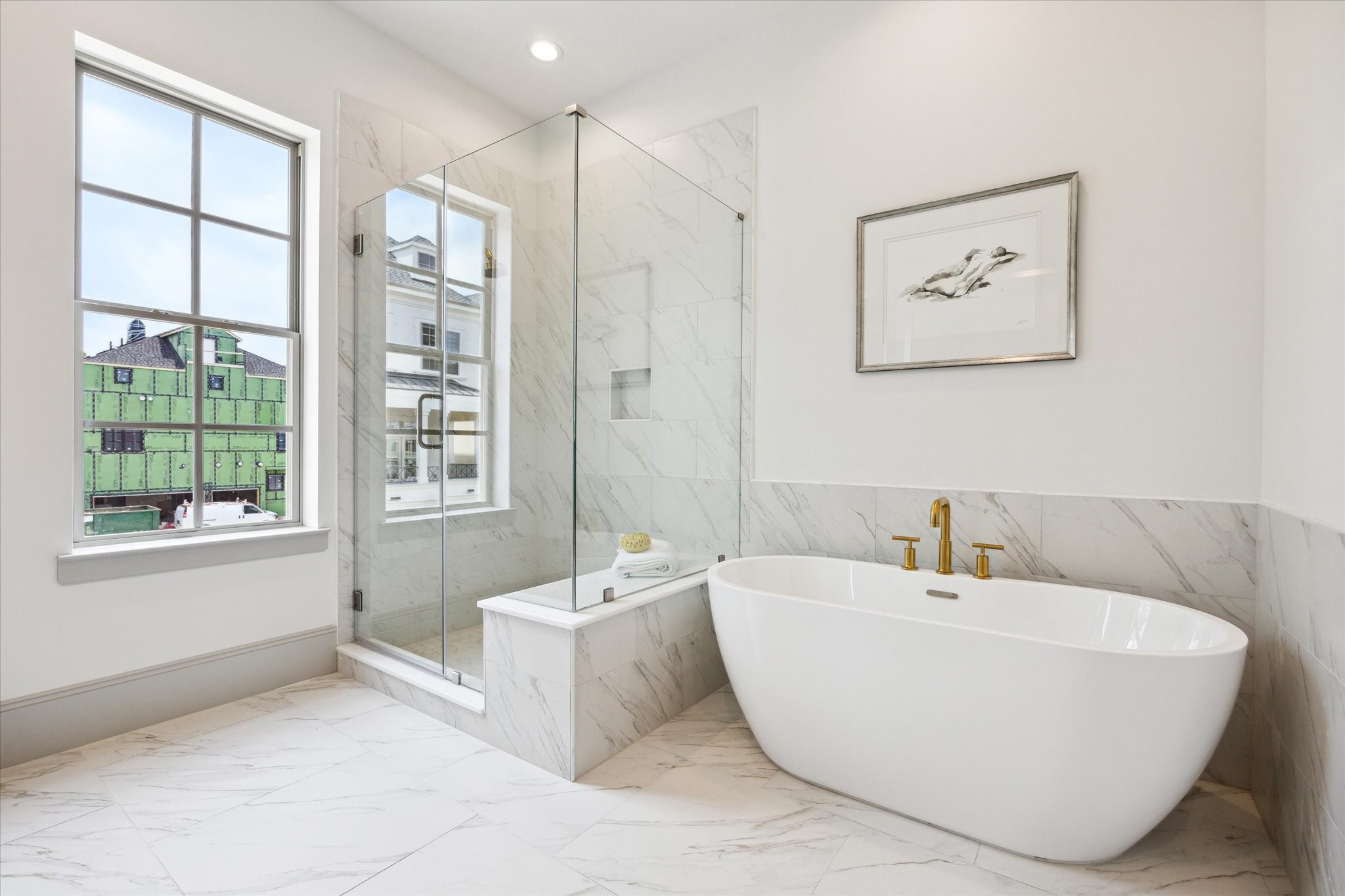 207 Sutton Row Place Houston, TX 77024 - Photo 16 of 29 Walk-in shower with seat, porcelain tile, marble tile floors, and brass hardware.