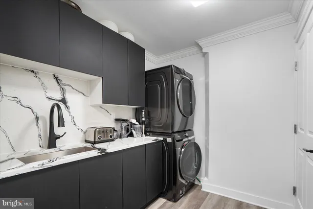 a kitchen with stainless steel appliances a refrigerator and a wooden floor
