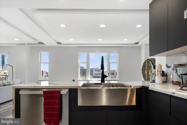 a kitchen with stainless steel appliances a sink stove and refrigerator