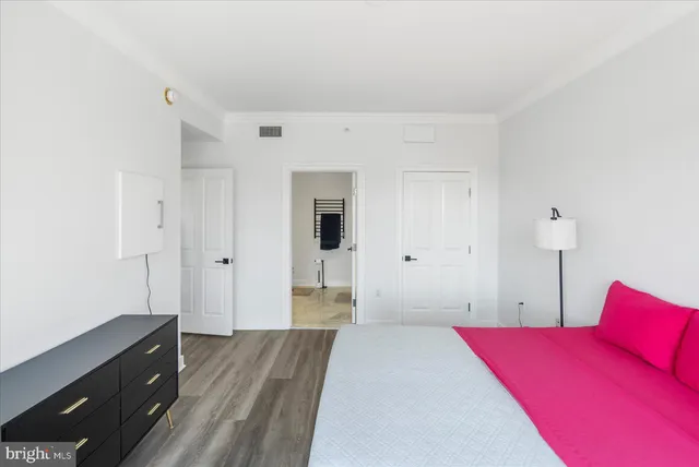 a bedroom with a large bed and a large window