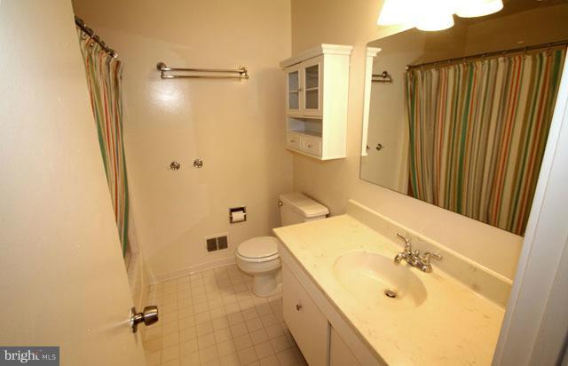 1105 North Rockingham Street Arlington, VA 22205 - Photo 17 of 24 a bathroom with a granite countertop sink toilet and shower