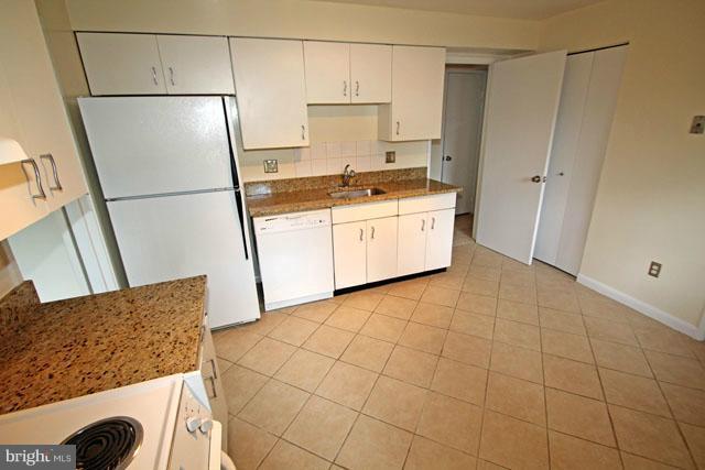 1105 North Rockingham Street Arlington, VA 22205 - Photo 3 of 24 a kitchen with stainless steel appliances a refrigerator sink and cabinets
