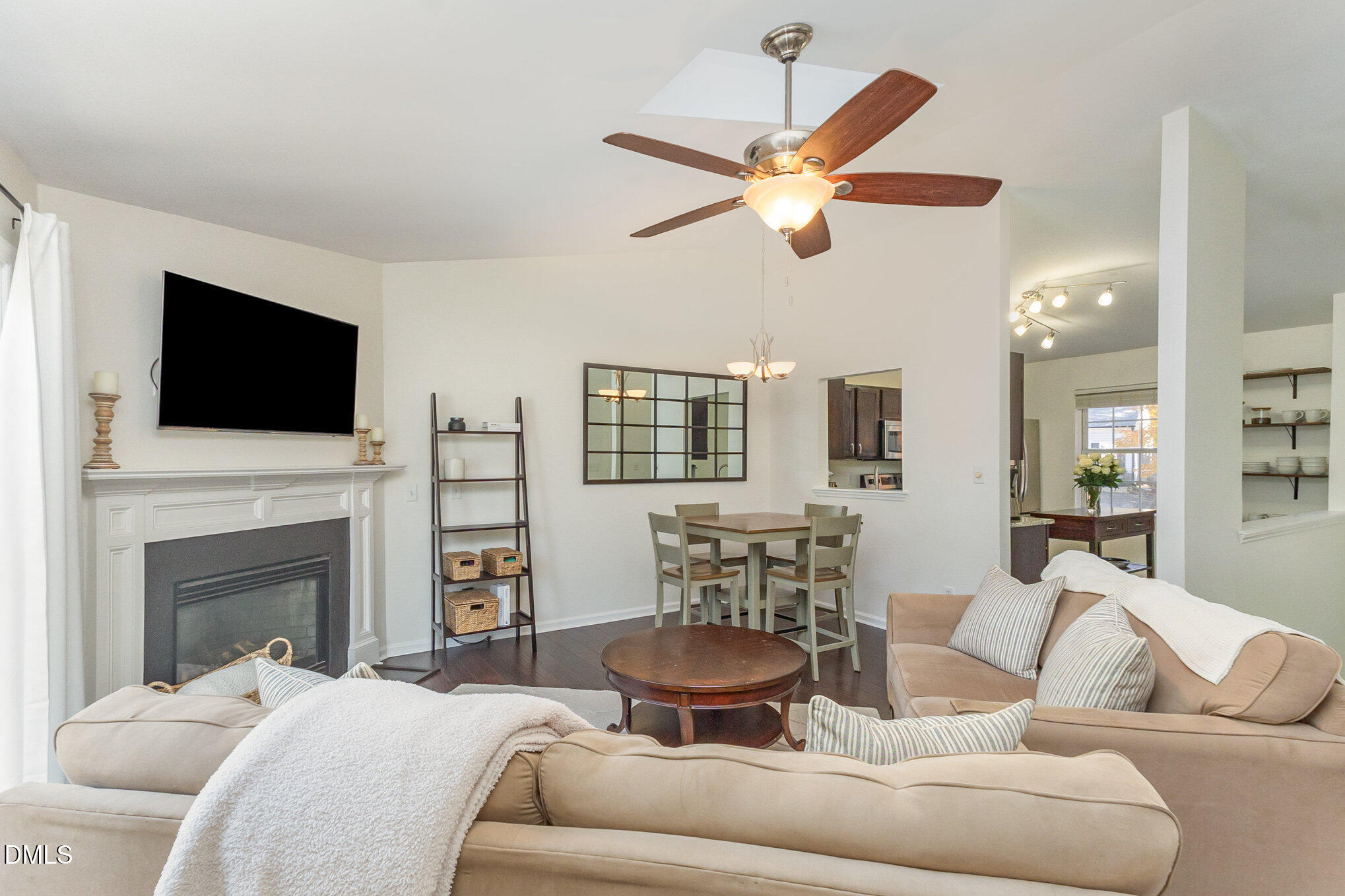 2211 Springhill Avenue Raleigh, NC 27603 - Photo 11 of 42 a living room with furniture a fireplace and a flat screen tv