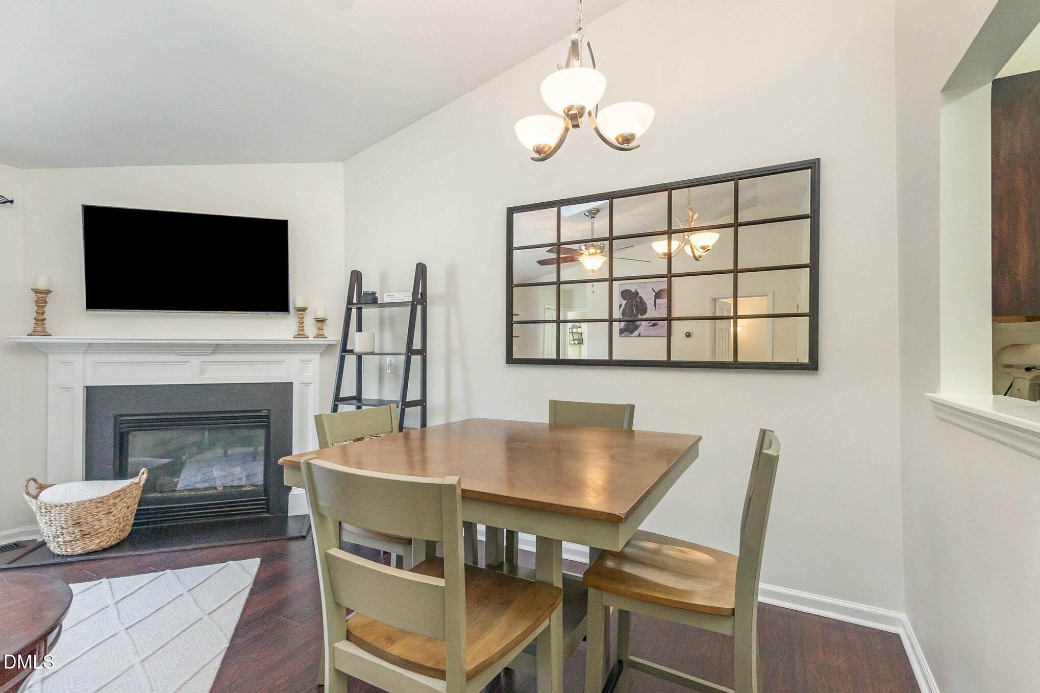 2211 Springhill Avenue Raleigh, NC 27603 - Photo 12 of 42 a dining room with furniture a fireplace and wooden floor