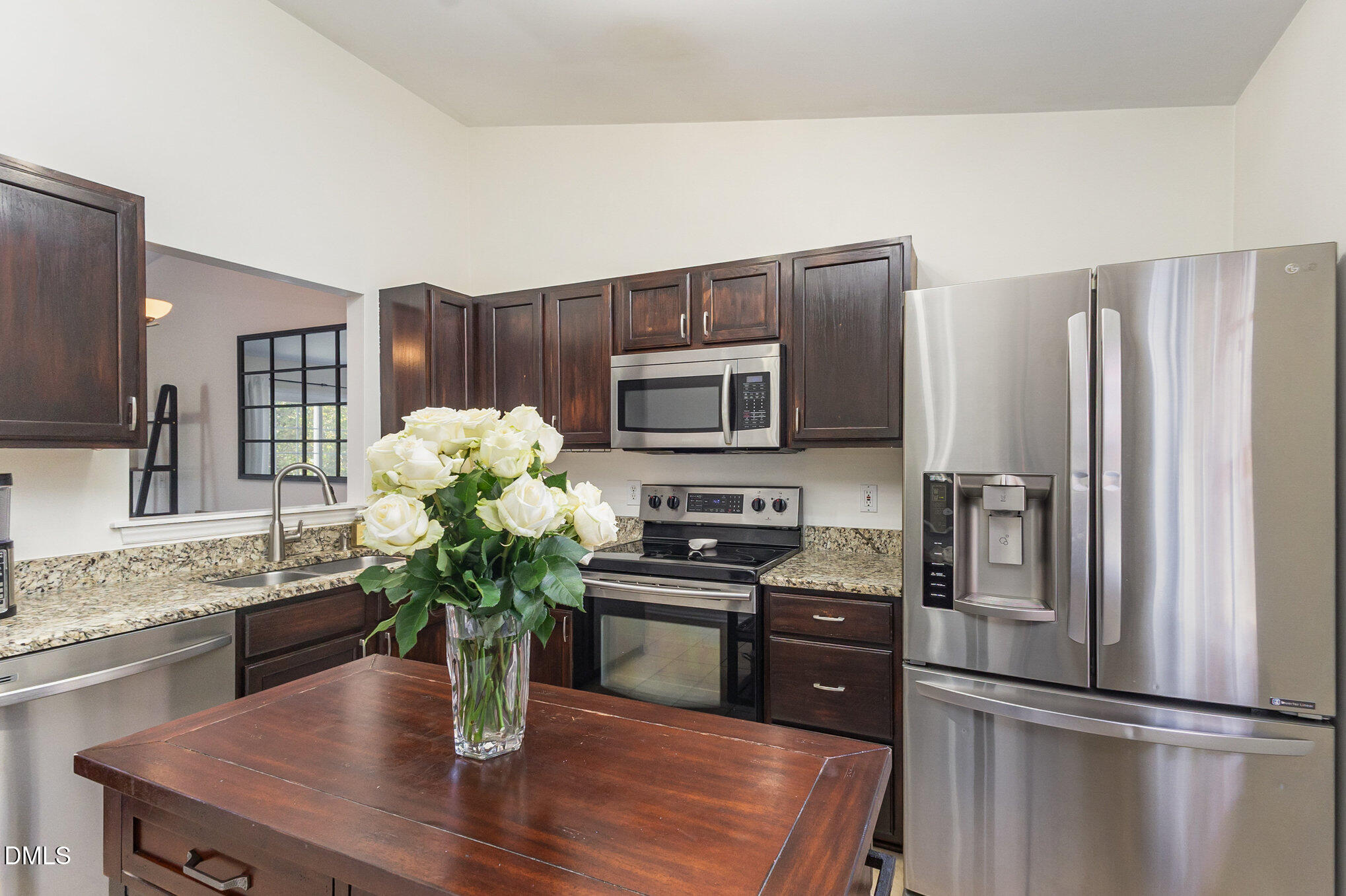 2211 Springhill Avenue Raleigh, NC 27603 - Photo 14 of 42 a kitchen with stainless steel appliances granite countertop a refrigerator a stove a microwave a sink a refrigerator with wooden floor