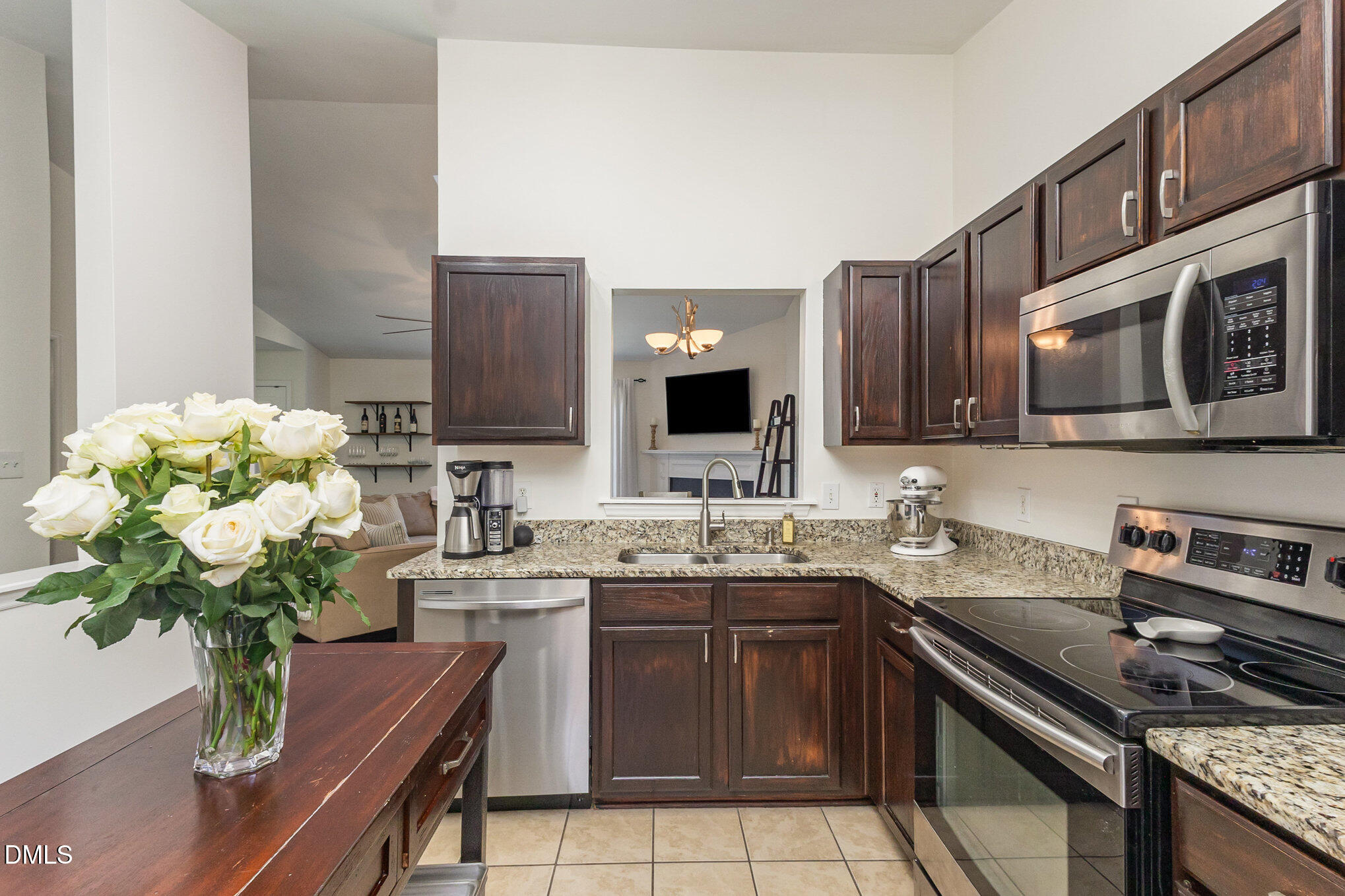 2211 Springhill Avenue Raleigh, NC 27603 - Photo 15 of 42 a kitchen with stainless steel appliances a sink a stove cabinets and a sink