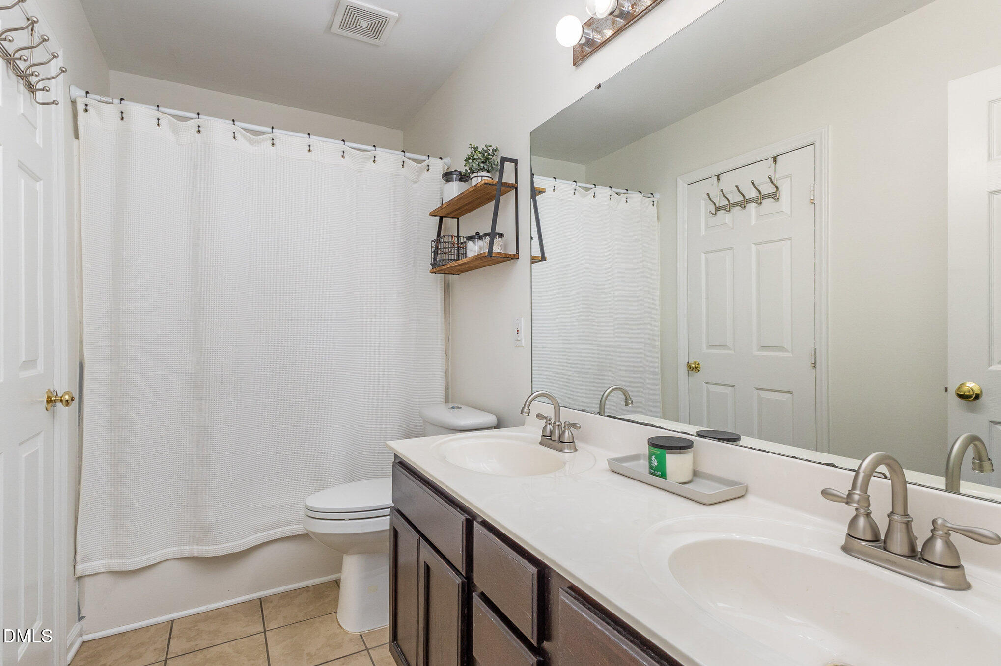 2211 Springhill Avenue Raleigh, NC 27603 - Photo 16 of 42 a bathroom with a sink a toilet and a mirror