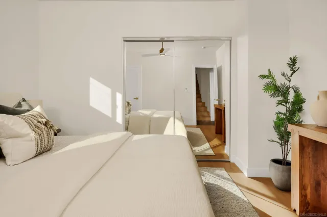 a living room with furniture a clock and a window