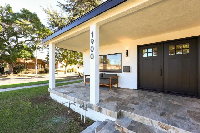 a view of a house with swimming pool and a yard