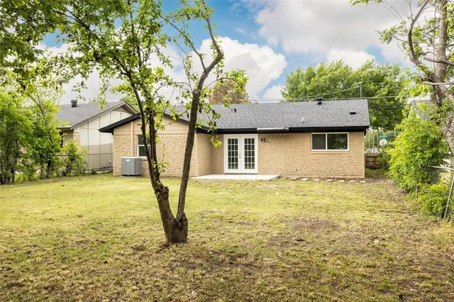 a view of a house with pool and a tree