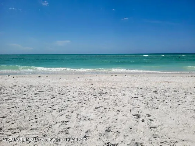 a view of room with an empty space and wooden floor