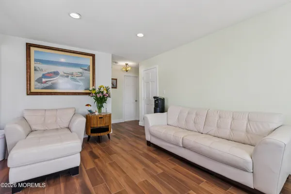 a bedroom with bed and wooden floor