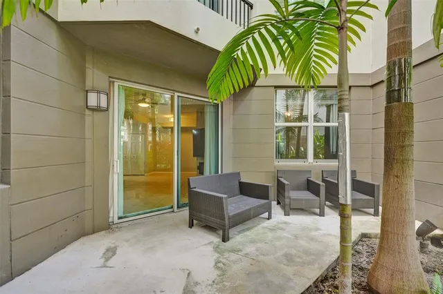 a balcony with furniture and a potted plant