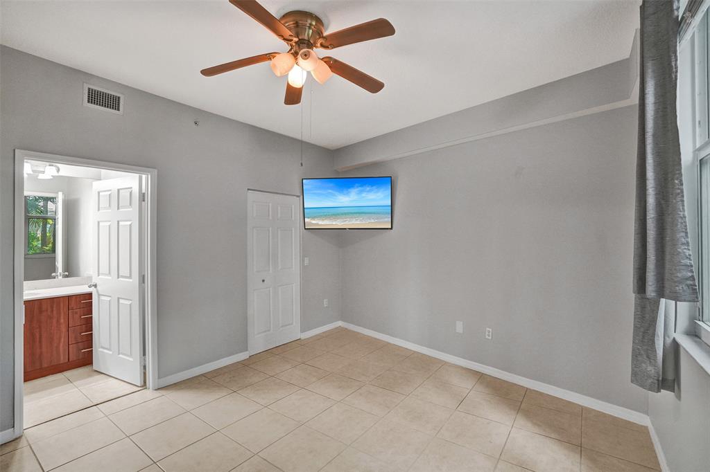 2421 Northeast 65th Street, Unit 2113 Fort Lauderdale, FL 33308 - Photo 16 of 45 an empty room with windows and fan