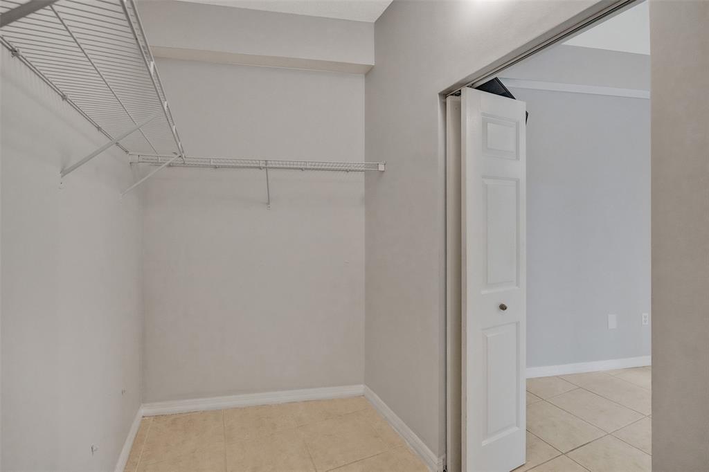 2421 Northeast 65th Street, Unit 2113 Fort Lauderdale, FL 33308 - Photo 19 of 45 a view of an empty walk in closet
