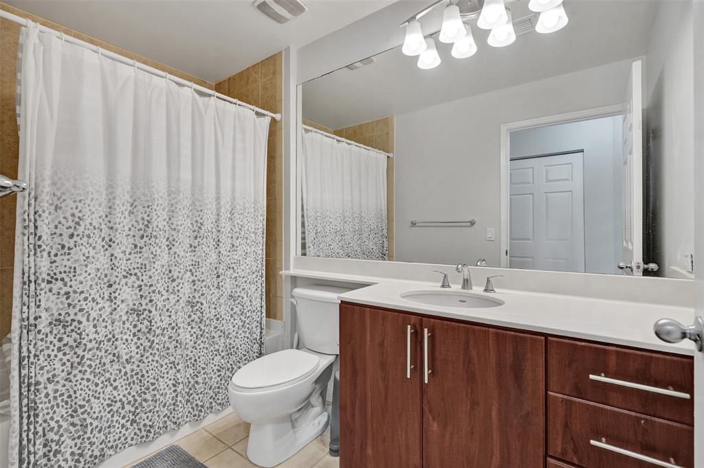 2421 Northeast 65th Street, Unit 2113 Fort Lauderdale, FL 33308 - Photo 24 of 45 a bathroom with a sink a toilet and shower