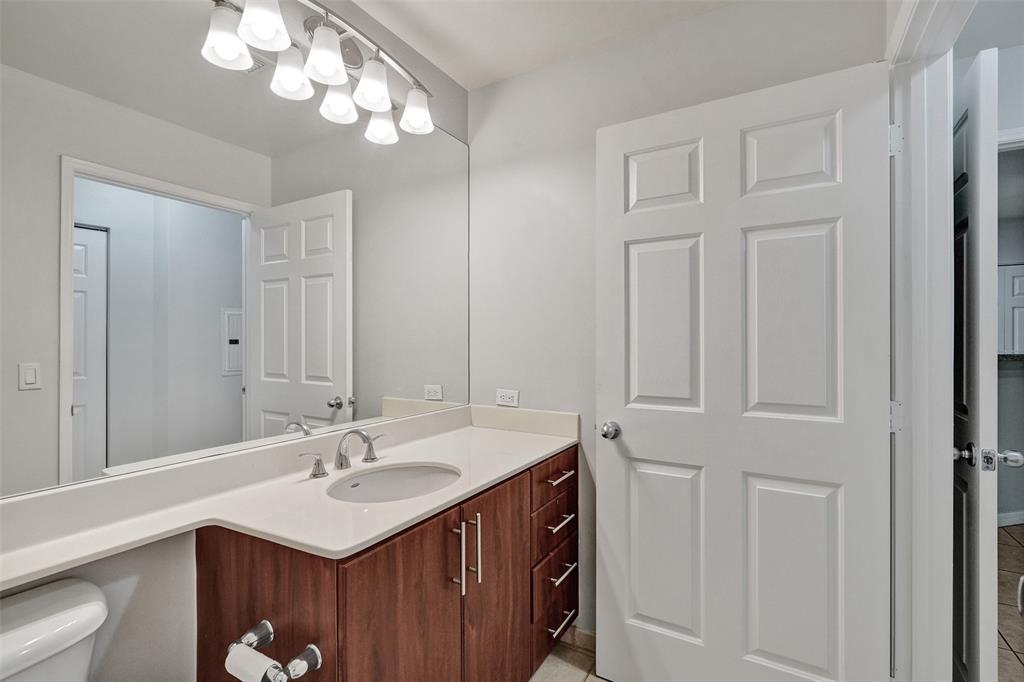 2421 Northeast 65th Street, Unit 2113 Fort Lauderdale, FL 33308 - Photo 27 of 45 a bathroom with a sink vanity and a mirror