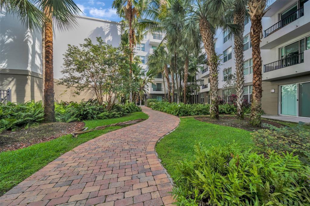 2421 Northeast 65th Street, Unit 2113 Fort Lauderdale, FL 33308 - Photo 33 of 45 a view of a yard with a house