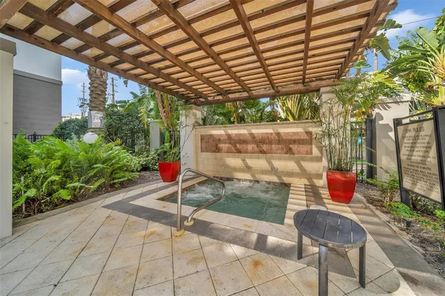 a living room with furniture gym equipment and a large window