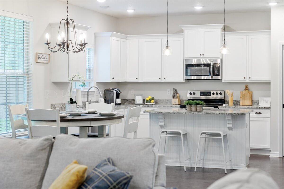 6206 Timberland Ridge Drive Crestview, FL 32539 - Photo 1 of 34 a kitchen with stainless steel appliances granite countertop a white cabinets and chairs