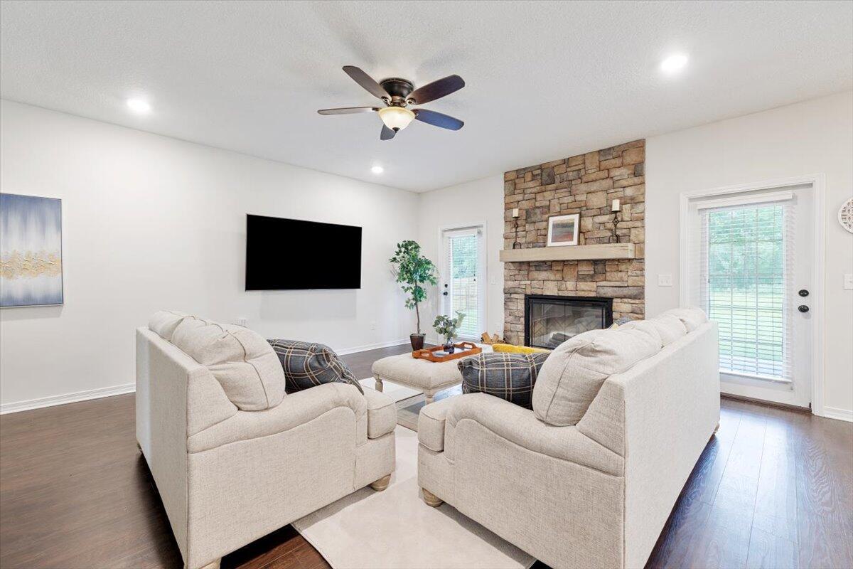 6206 Timberland Ridge Drive Crestview, FL 32539 - Photo 17 of 34 a living room with furniture a flat screen tv and a fireplace