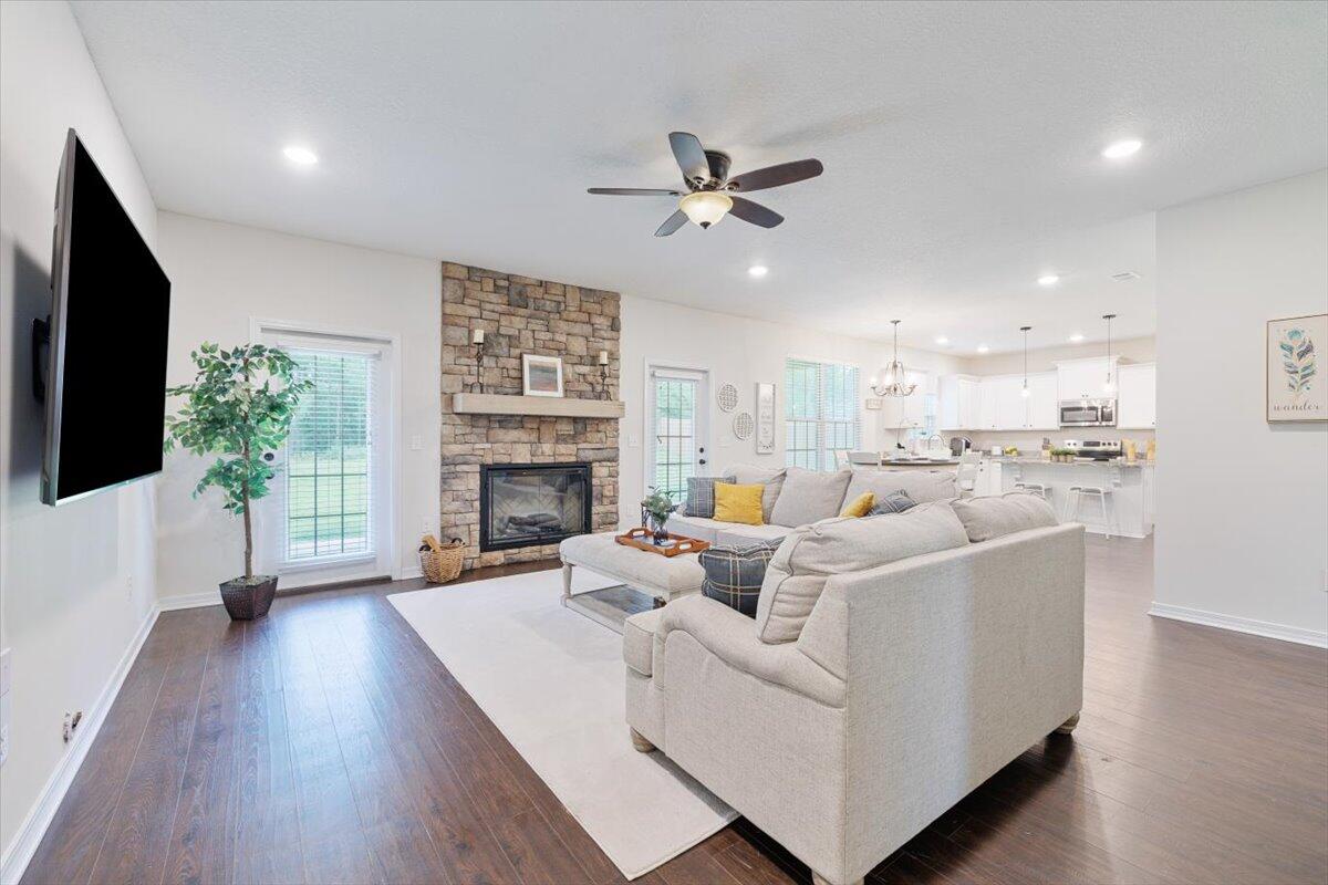 6206 Timberland Ridge Drive Crestview, FL 32539 - Photo 18 of 34 a living room with furniture a fireplace and a flat screen tv