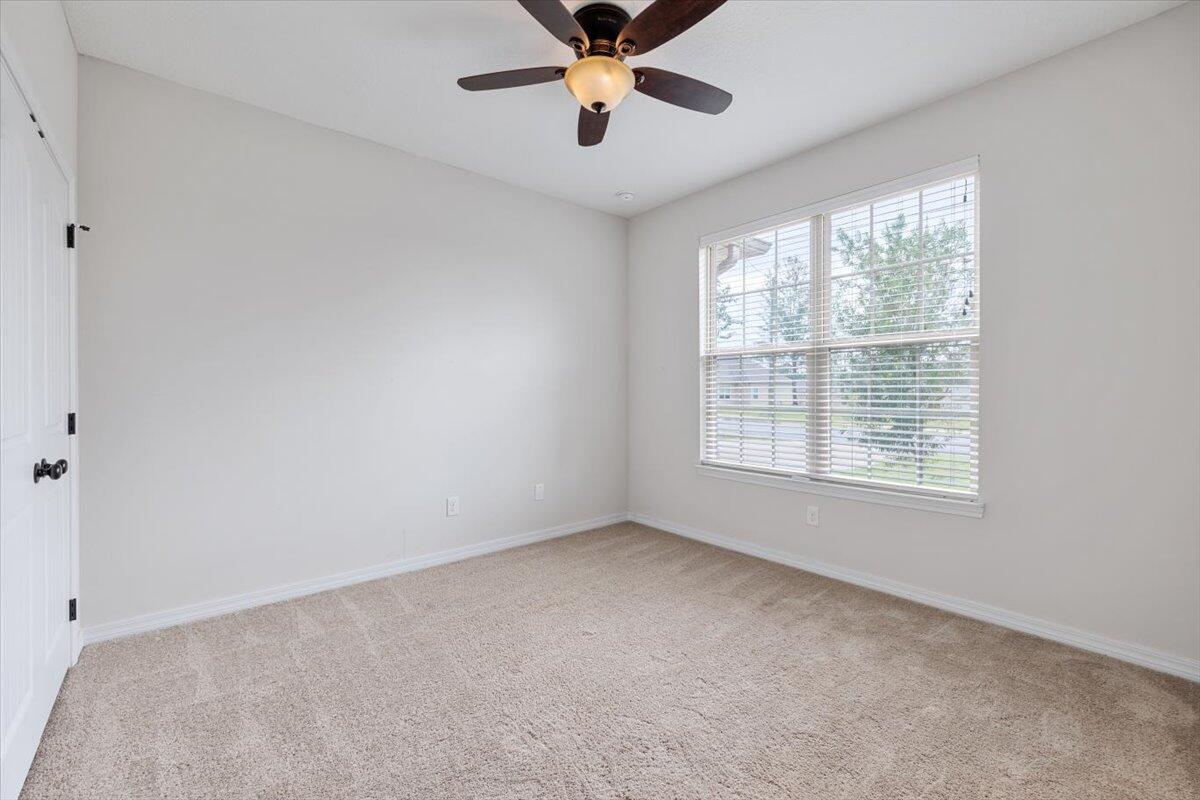 6206 Timberland Ridge Drive Crestview, FL 32539 - Photo 24 of 34 a view of an empty room with window and a ceiling fan