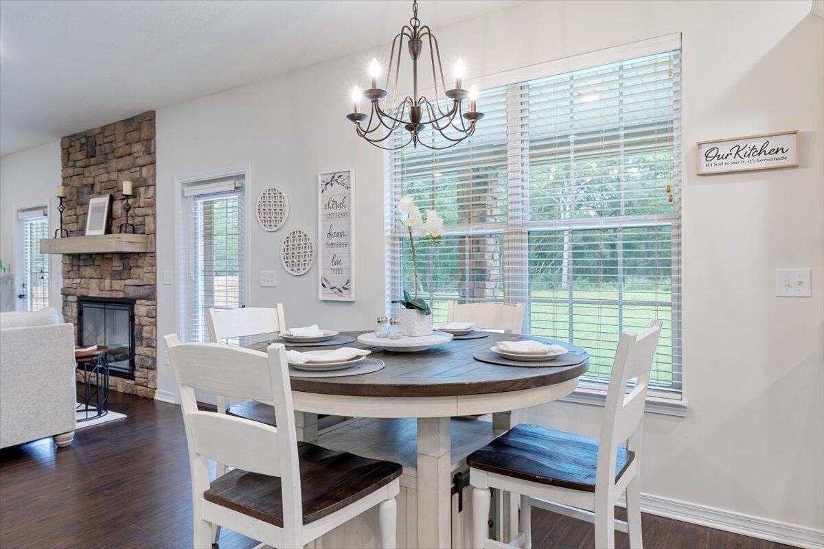6206 Timberland Ridge Drive Crestview, FL 32539 - Photo 26 of 34 a view of a dining room with furniture wooden floor and chandelier
