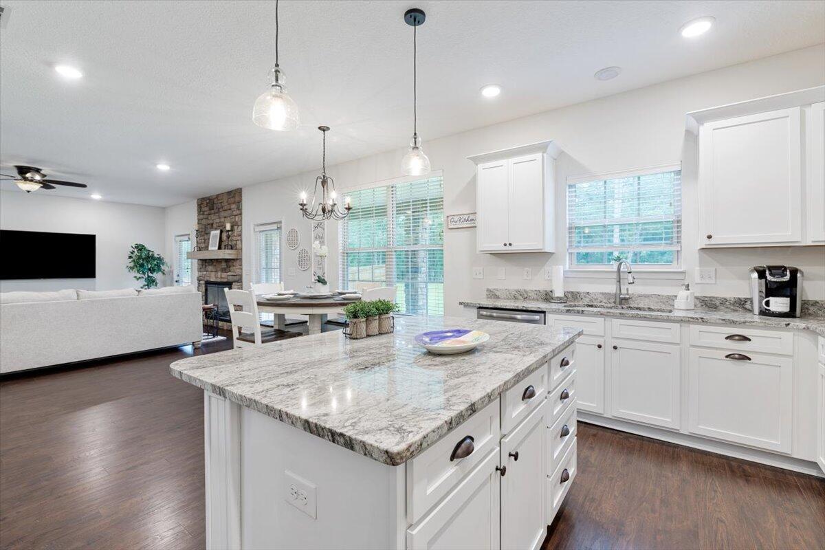 6206 Timberland Ridge Drive Crestview, FL 32539 - Photo 27 of 34 a kitchen with stainless steel appliances granite countertop a sink stove and white cabinets with wooden floor