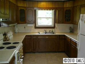 2091 Junction Road Cooleemee, NC 27014 - Photo 2 of 8 a kitchen with a sink and a stove next to a window