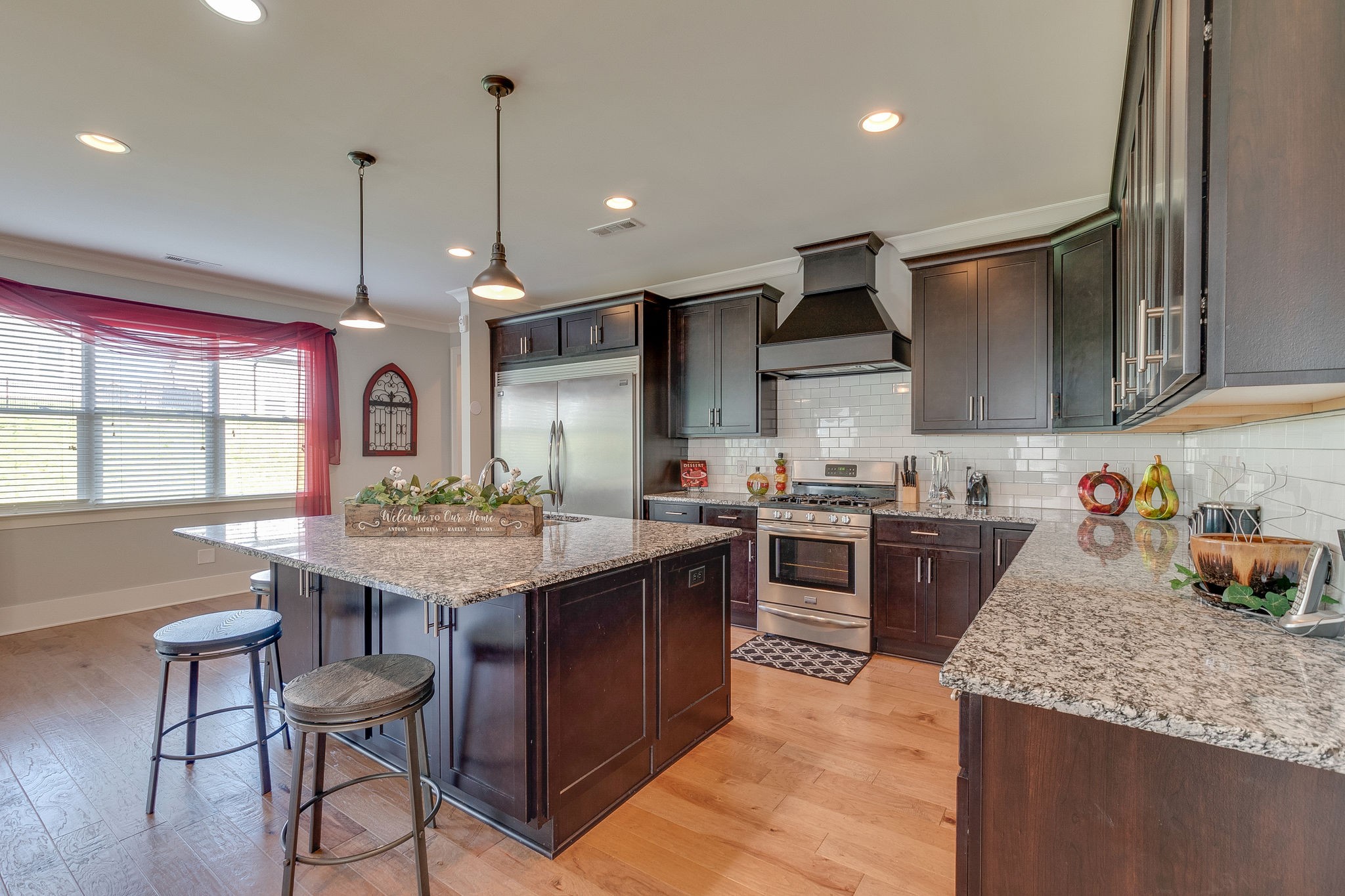 115 Vanner Road Mount Juliet, TN 37122 - Photo 16 of 42 a kitchen with stainless steel appliances granite countertop table chairs sink and stove top oven