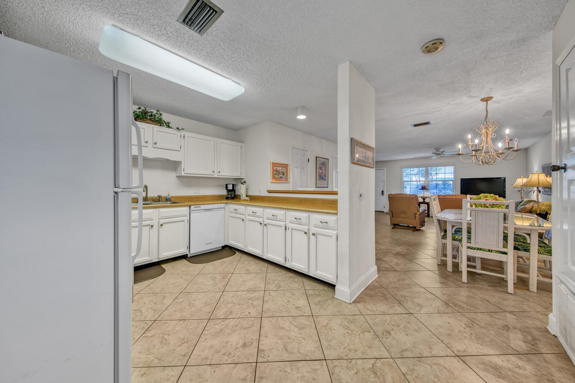 241 Ellis Road, Unit 4 Miramar Beach, FL 32550 - Photo 11 of 30 a kitchen with a sink a counter top space appliances and cabinets