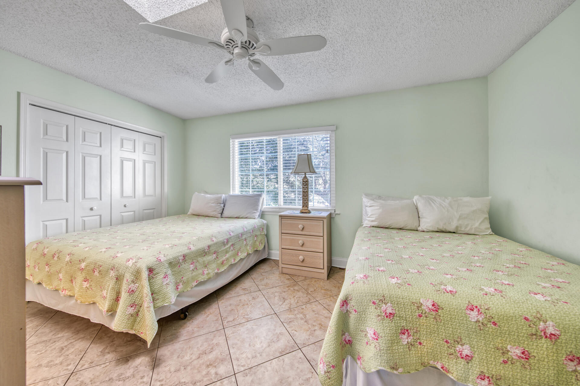 241 Ellis Road, Unit 4 Miramar Beach, FL 32550 - Photo 14 of 30 a bedroom with a large bed and a chandelier