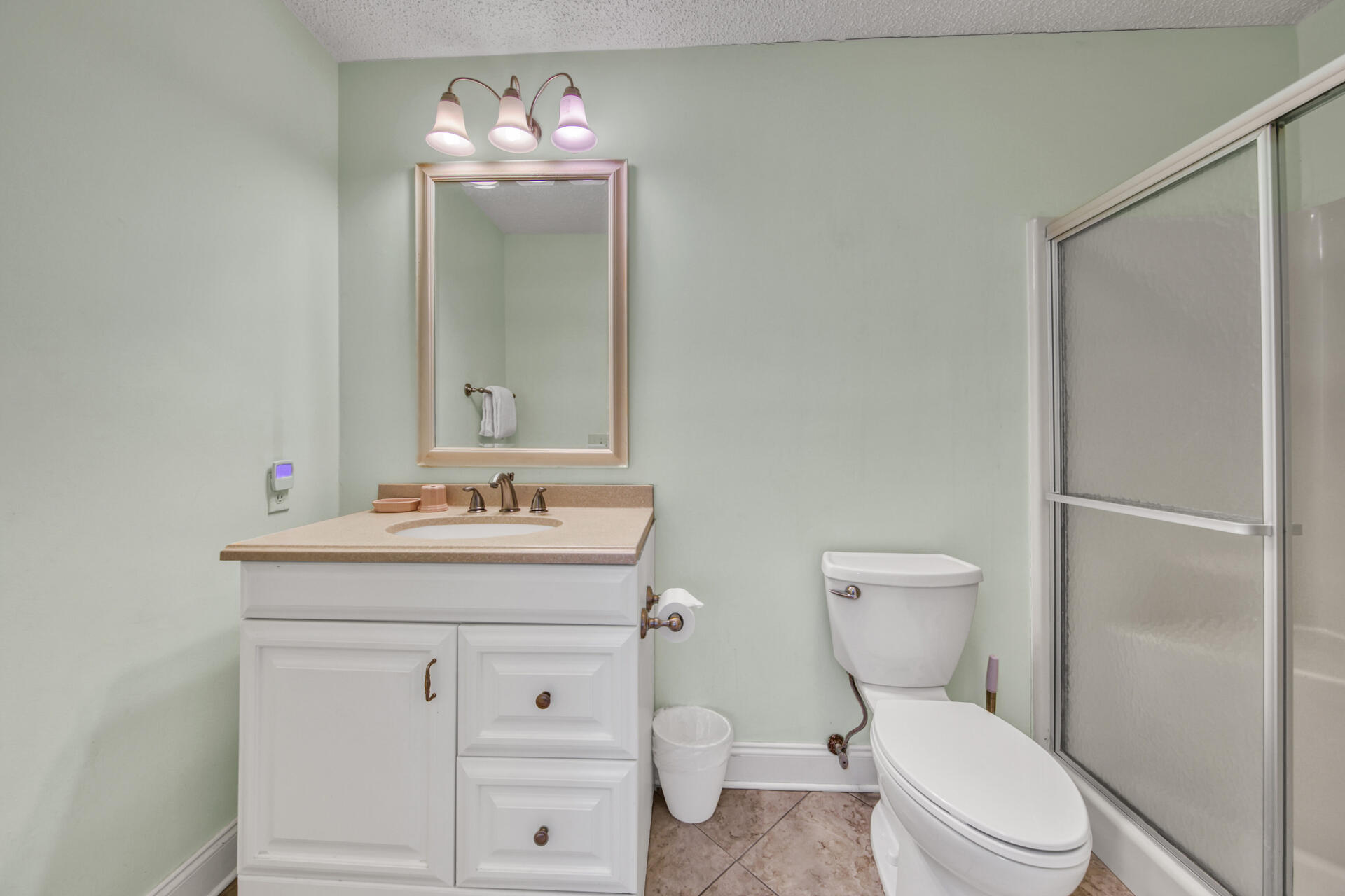 241 Ellis Road, Unit 4 Miramar Beach, FL 32550 - Photo 16 of 30 a bathroom with a toilet sink vanity and mirror