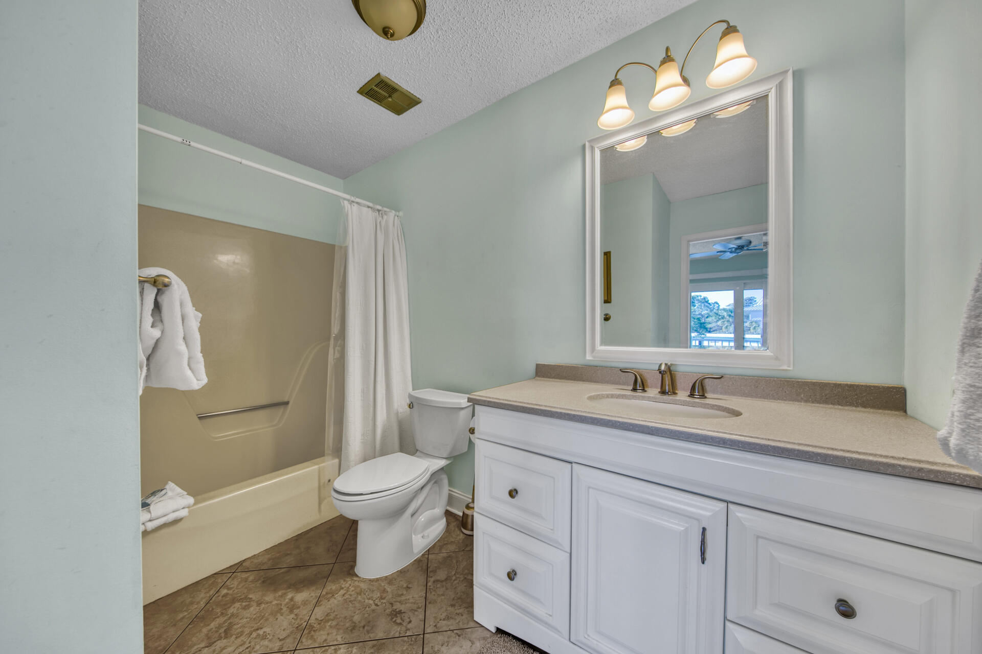241 Ellis Road, Unit 4 Miramar Beach, FL 32550 - Photo 20 of 30 a spacious bathroom with a granite countertop sink a toilet and a mirror
