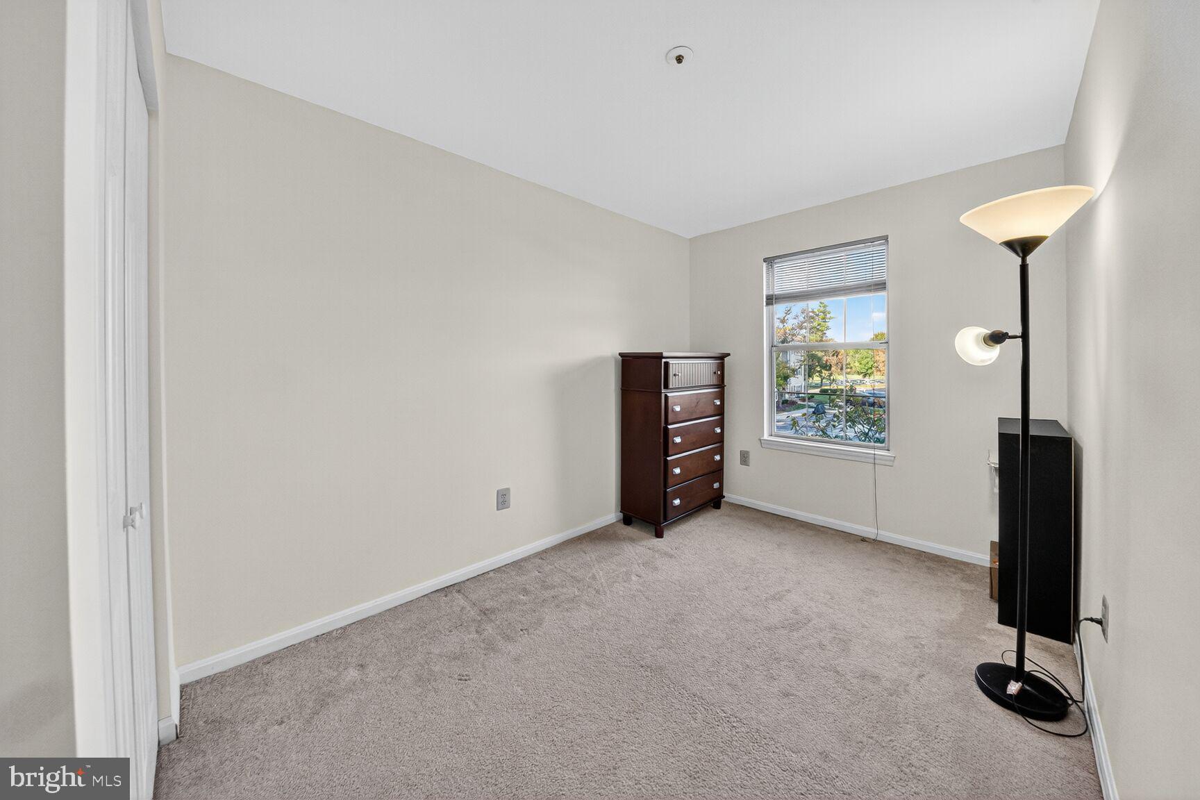 14901 McKisson Court, Unit 7CC Silver Spring, MD 20906 - Photo 15 of 34 an empty room with windows and flowerpot