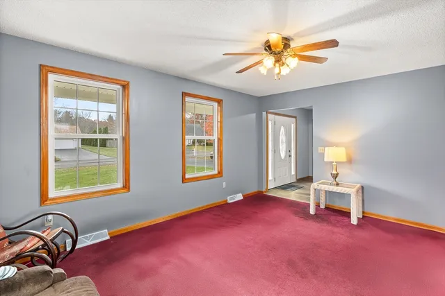 a view of a livingroom with couch and a dining room