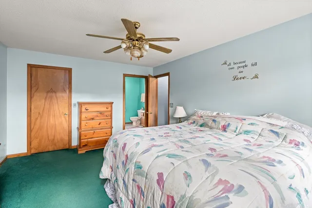 a bathroom with a sink mirror and toilet