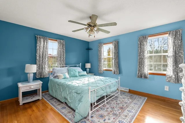 a bedroom with a large bed and a chandelier
