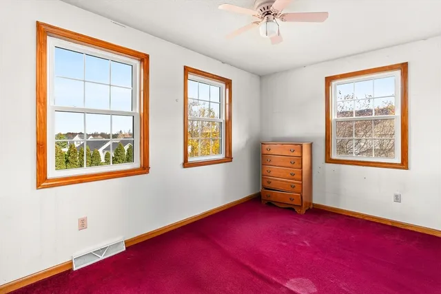 a room with lounge chair and a window