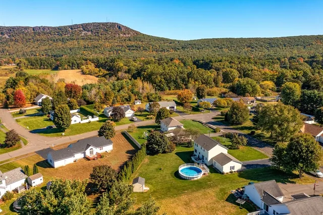 an aerial view of residential houses with outdoor space