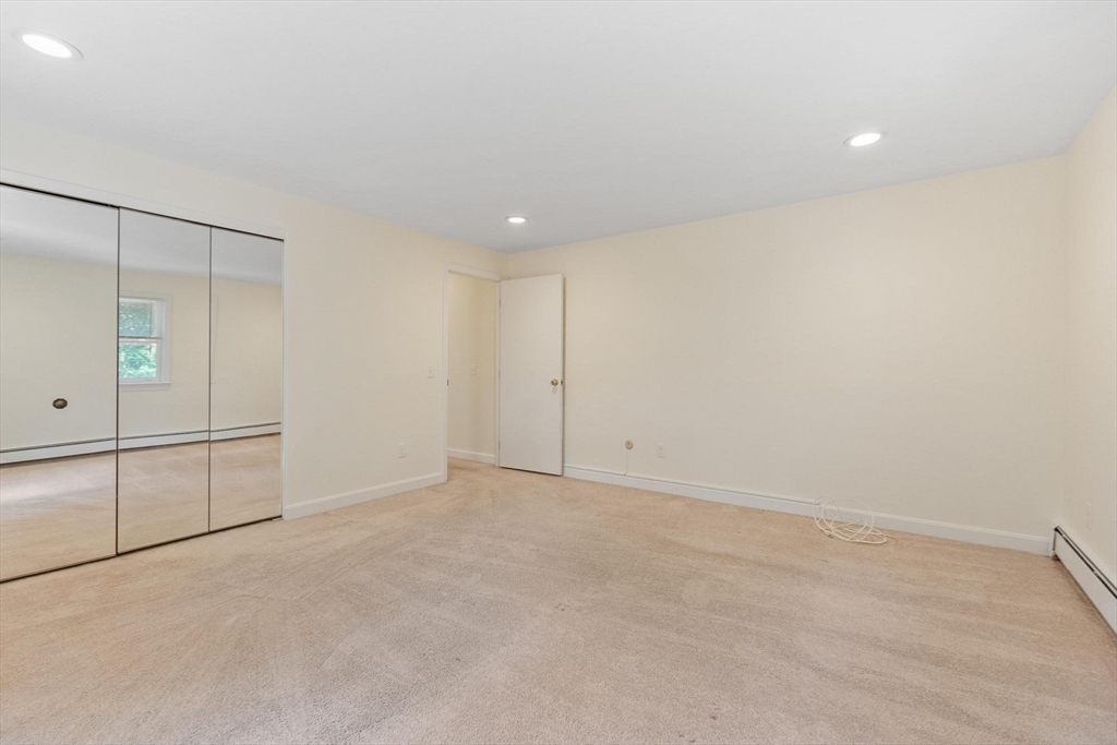 420 Great Road, Unit C1 Acton, MA 01720 - Photo 12 of 29 an empty room with cabinet and mirrors