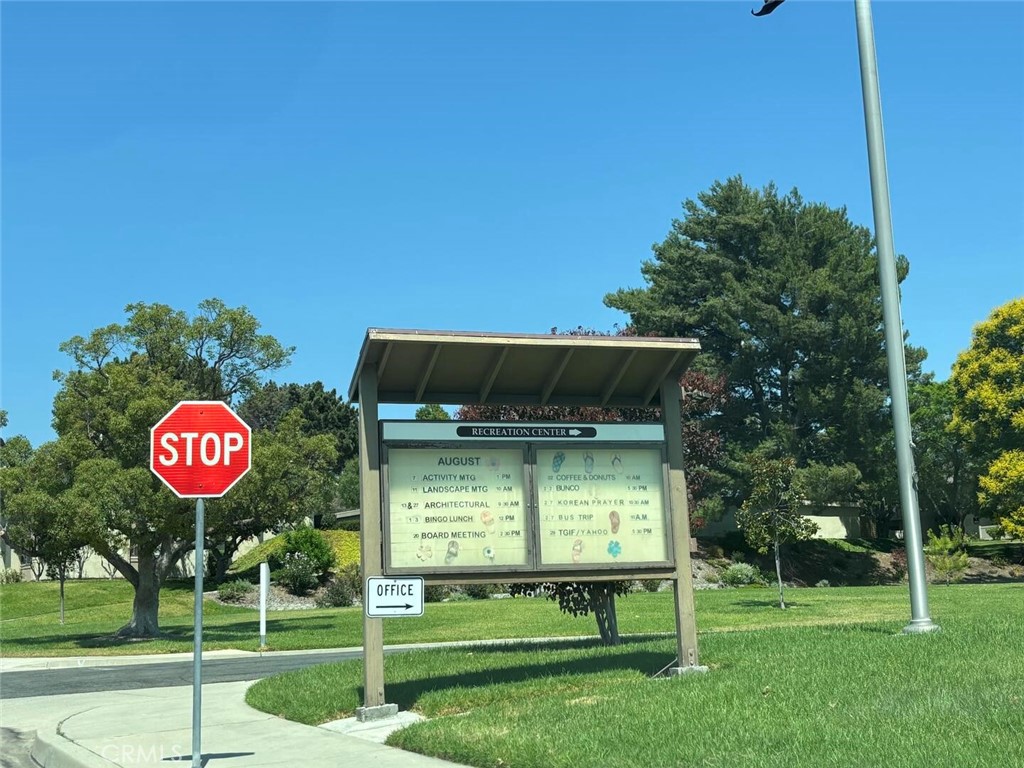 13634 La Jolla Circle, Unit 13E La Mirada, CA 90638 - Photo 19 of 32 a view of a park that has a sign board large trees and a big yard