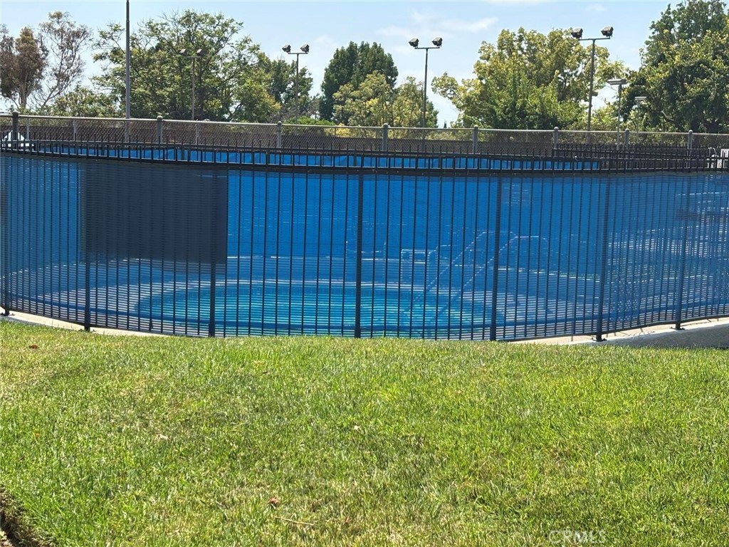 13634 La Jolla Circle, Unit 13E La Mirada, CA 90638 - Photo 27 of 32 a view of a backyard with a fence and trees