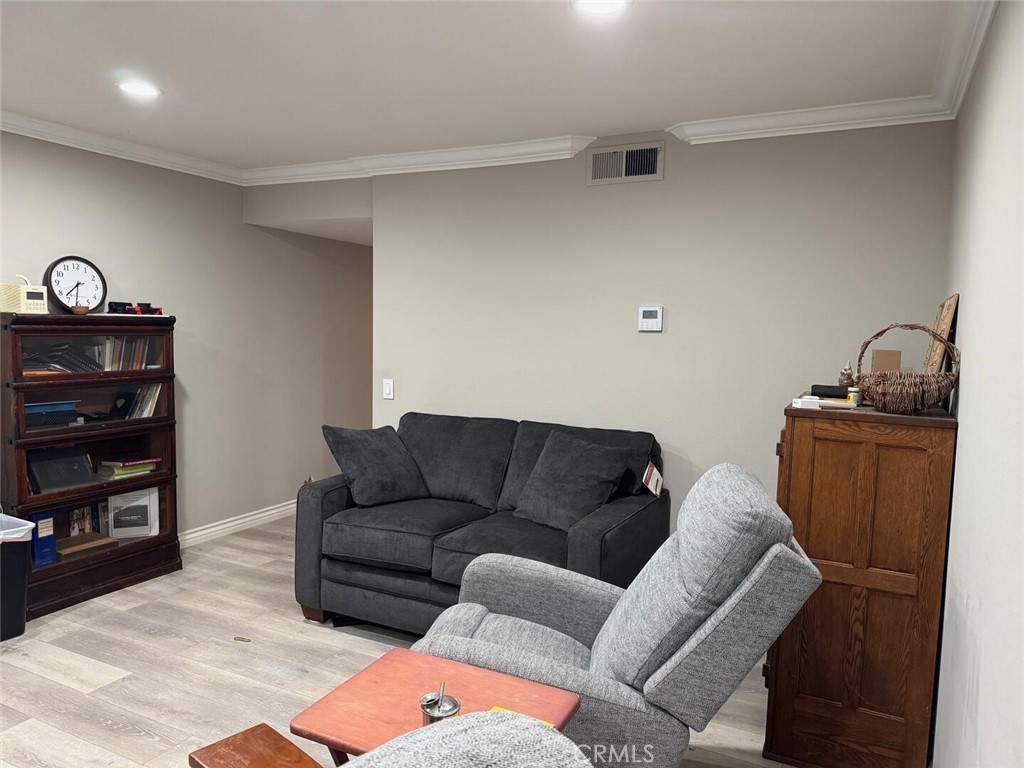 13634 La Jolla Circle, Unit 13E La Mirada, CA 90638 - Photo 6 of 32 a living room with furniture a flat screen tv and a dresser with wooden floor