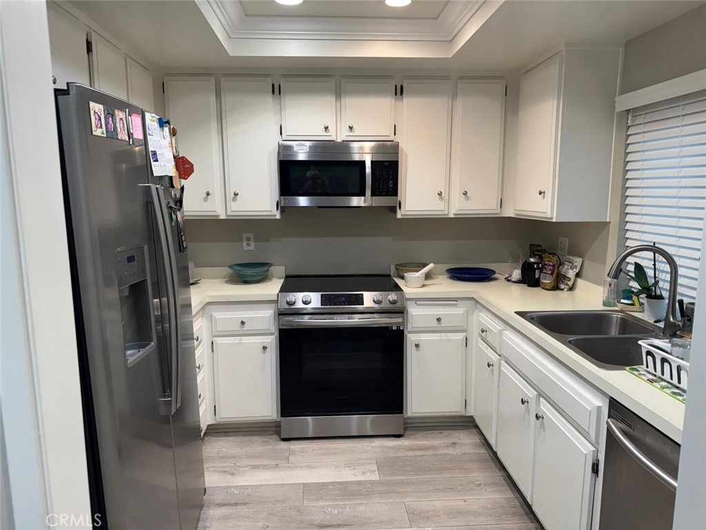 13634 La Jolla Circle, Unit 13E La Mirada, CA 90638 - Photo 8 of 32 a kitchen with a refrigerator sink and cabinets