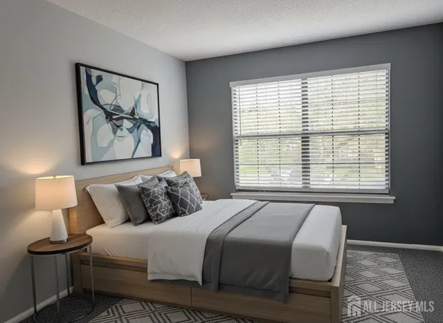 a bedroom with a bed and a painting on the wall