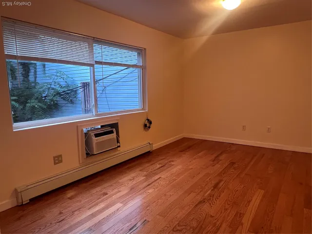 a view of a room with wooden floor and fan